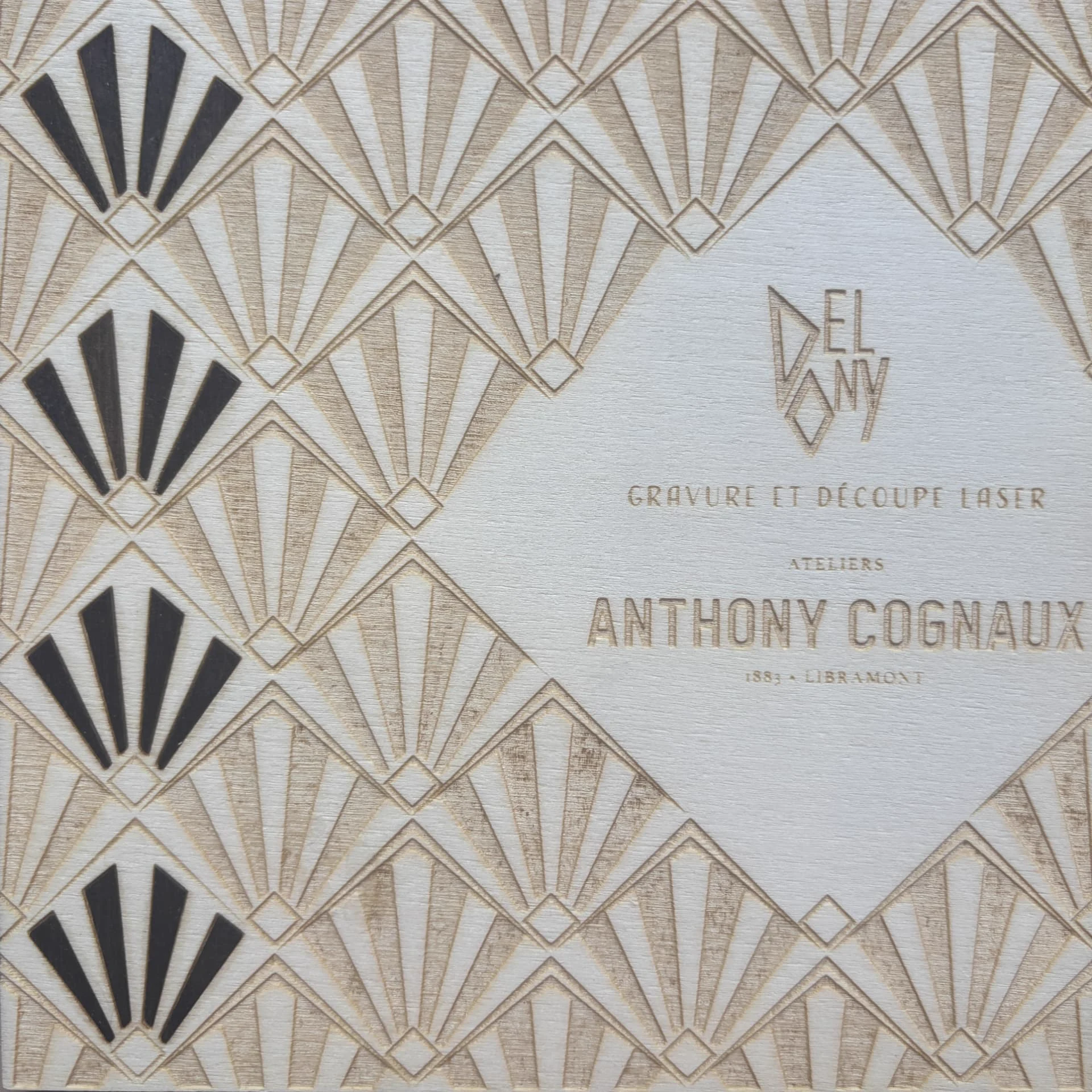 Panneau de bois gravé d'un motif art déco et du logo Delony